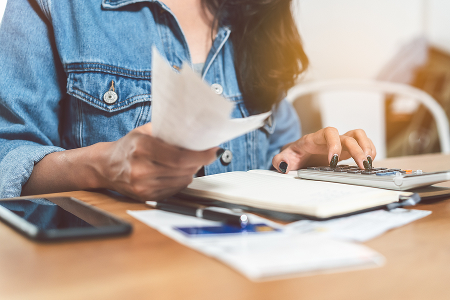 a woman calculating personal finances and debt