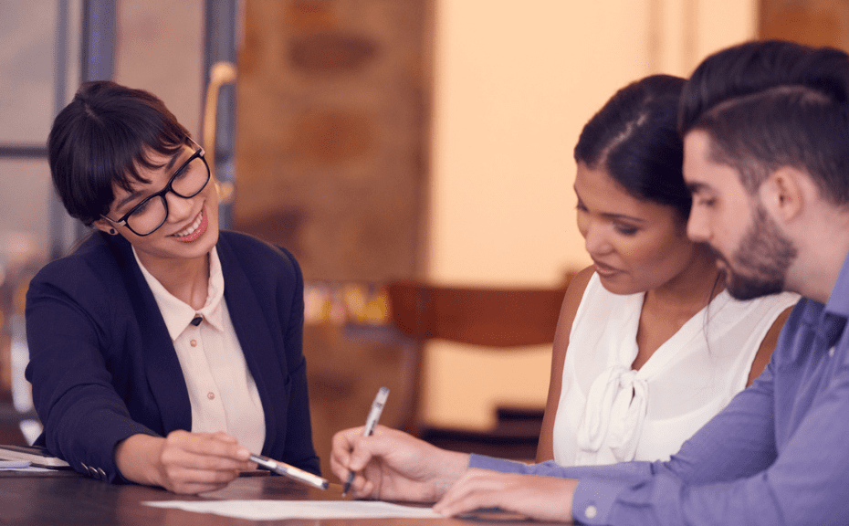 A couple consulting with woman about an auto refinance