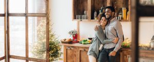 A couple hugs in their kitchen after completing some home improvement projects using funds from a home equity loan.