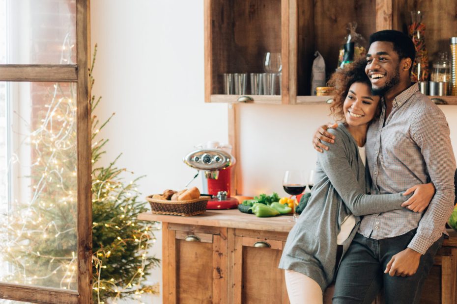 A couple hugs in their kitchen after completing some home improvement projects using funds from a home equity loan.