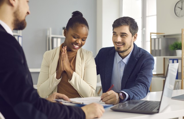 A happy couple discussing their mortgage closing costs