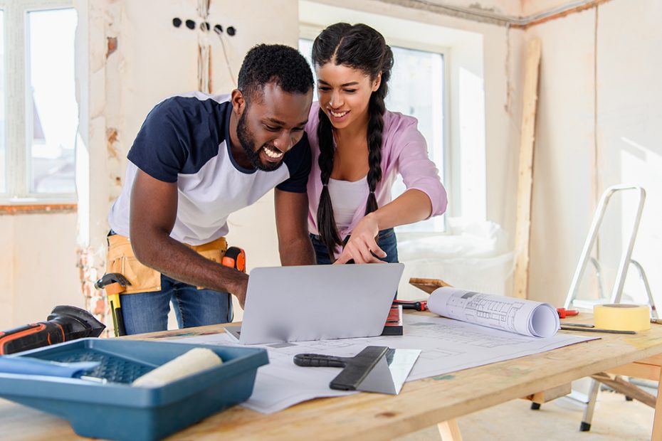 A couple uses a laptop during home renovations to keep track of HELOC and home equity loan tax deductions.